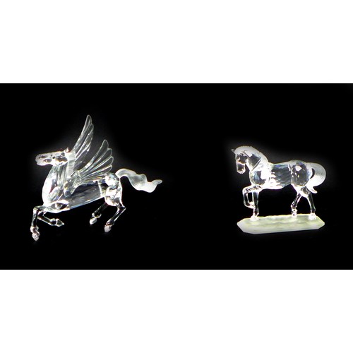 87 - Two Swarovski crystal ornaments, comprising Pegasus, A7400 NR 098 000, 12cm high, with certificate, ... 