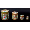 A group of four Chinese Canton porcelain cylindrical pots and covers in graduating sizes, late 19th ... 