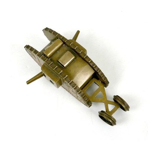 116 - A WWI trench art brass Mk 1 tank, with two side guns, and rear steering wheels, 13 by 4.8 by 4.2cm h... 