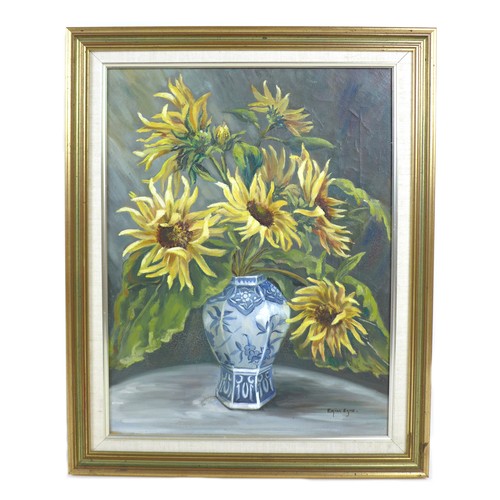 84 - A 20th century still life of sunflowers in a blue and white vase, oil on canvas, signed 'Erica Eske'... 