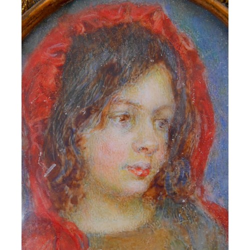 74 - British School (late 19th century): an oval portrait miniature, depicting a young girl wearing a red... 