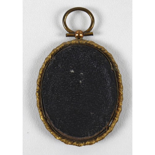 74 - British School (late 19th century): an oval portrait miniature, depicting a young girl wearing a red... 