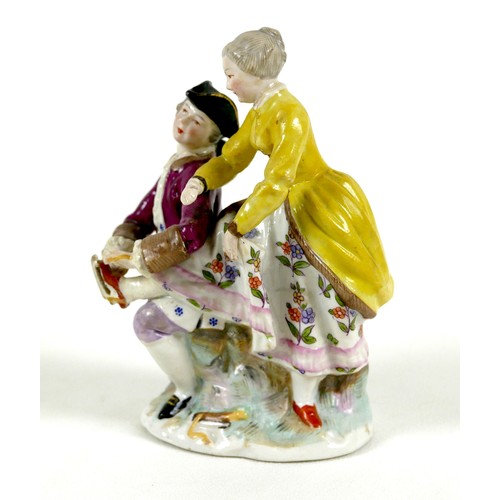 33 - A Continental 19th century porcelain figure group, in the style of Dresden, modelled as a gentleman ... 