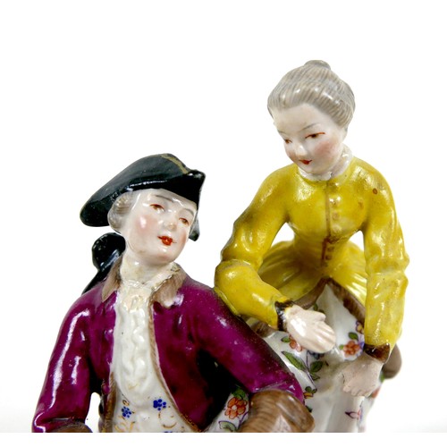 33 - A Continental 19th century porcelain figure group, in the style of Dresden, modelled as a gentleman ... 