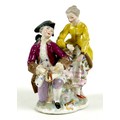 A Continental 19th century porcelain figure group, in the style of Dresden, modelled as a gentleman ... 
