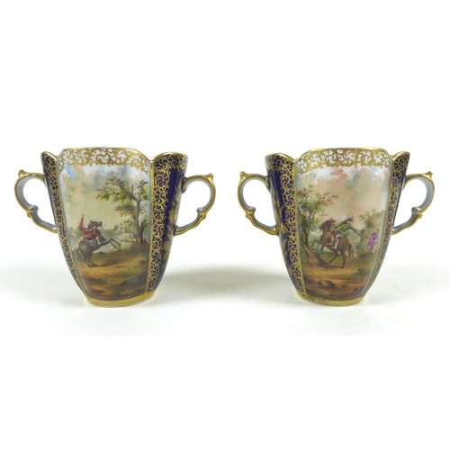 28 - A pair of Dresden porcelain cabinet twin handled cups and quatrefoil saucers, late 19th century, dec... 