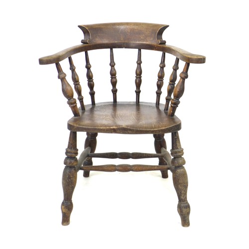 235 - A 19th century oak smokers bow armchair, with stamped maker's mark 'Johnson Holland & Co, Wycombe, 1... 