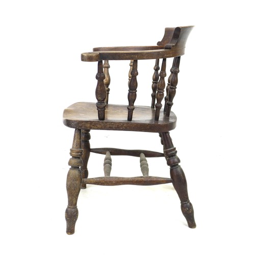 235 - A 19th century oak smokers bow armchair, with stamped maker's mark 'Johnson Holland & Co, Wycombe, 1... 