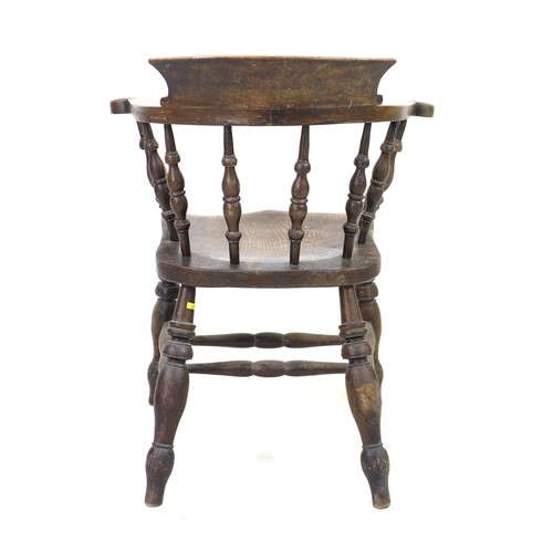 235 - A 19th century oak smokers bow armchair, with stamped maker's mark 'Johnson Holland & Co, Wycombe, 1... 