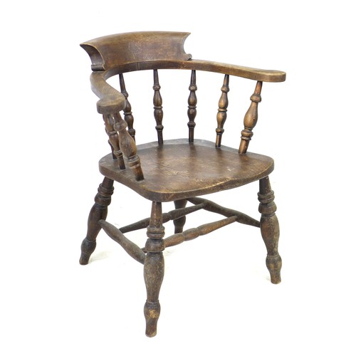 235 - A 19th century oak smokers bow armchair, with stamped maker's mark 'Johnson Holland & Co, Wycombe, 1... 