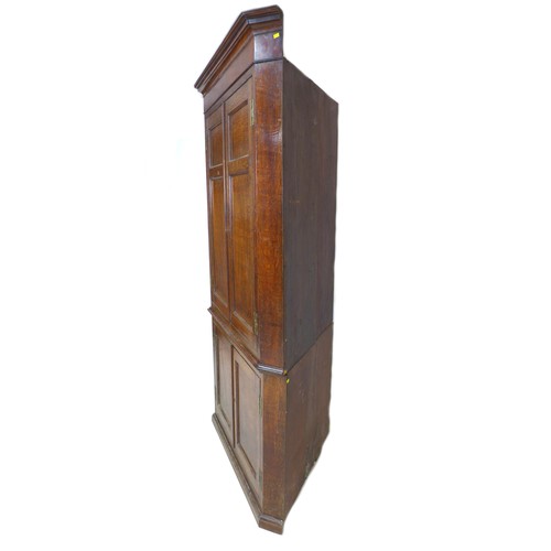 238 - A George III oak and mahogany corner cupboard, floor-standing, with panelled doors and shelved inter... 