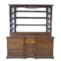 A George II oak dresser, the rack with three shelves above six short drawers flanked by compartments... 