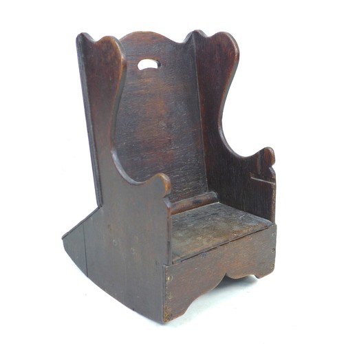 236 - An early 18th century oak child’s potty chair, with wing back and lift seat, 37.5 by 42 by 60cm high... 