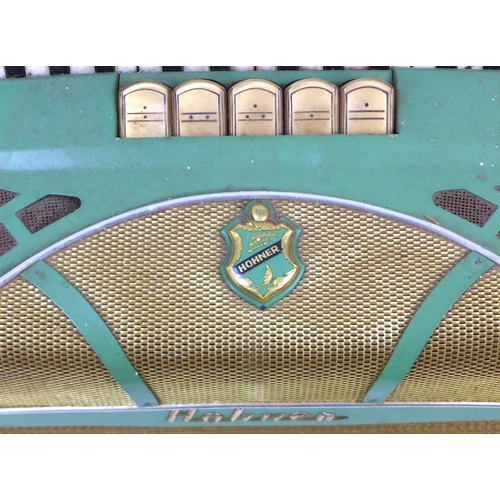 121 - A vintage Hohner piano accordion, Lucia II Musette, pale green, in working order.