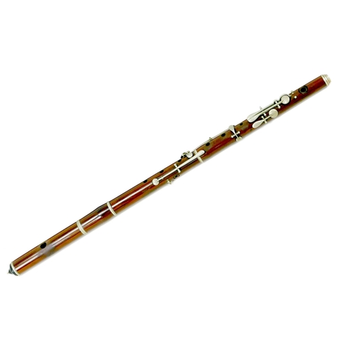 122 - A late 19th/early 20th century rosewood flute, three sections with white metal mounts and keys, ebon... 