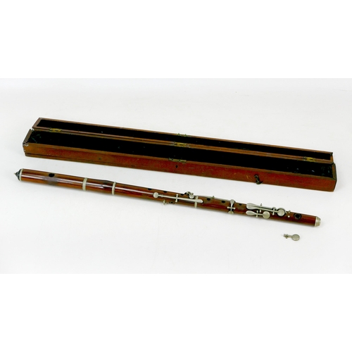 122 - A late 19th/early 20th century rosewood flute, three sections with white metal mounts and keys, ebon... 