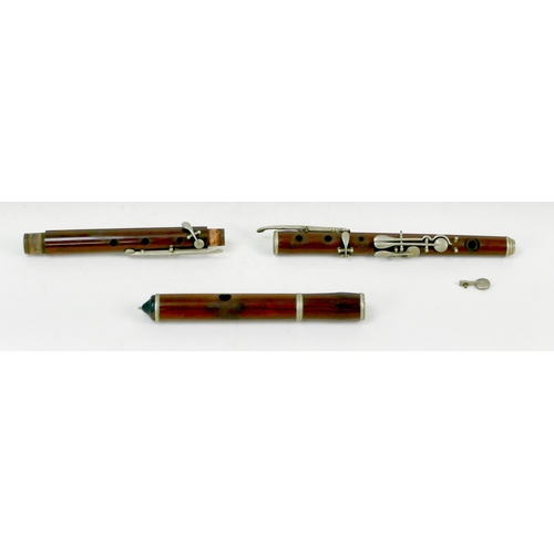 122 - A late 19th/early 20th century rosewood flute, three sections with white metal mounts and keys, ebon... 