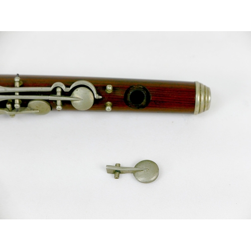 122 - A late 19th/early 20th century rosewood flute, three sections with white metal mounts and keys, ebon... 