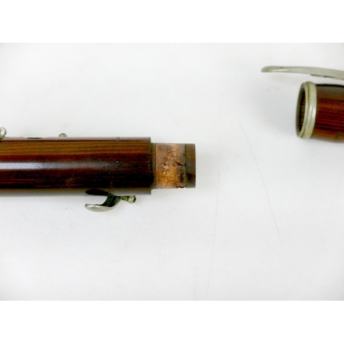 122 - A late 19th/early 20th century rosewood flute, three sections with white metal mounts and keys, ebon... 