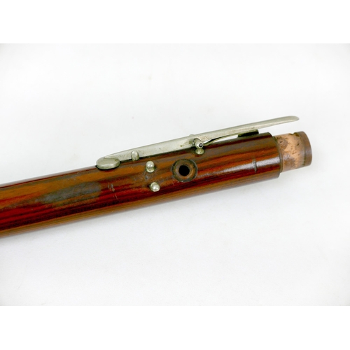 122 - A late 19th/early 20th century rosewood flute, three sections with white metal mounts and keys, ebon... 