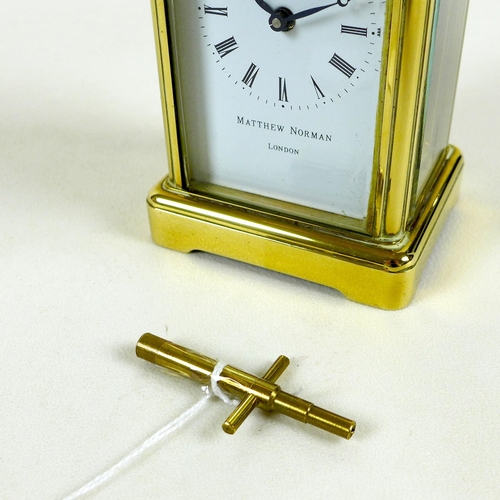 138 - A brass carriage clock by Matthew Norman, circa 1980s, the white dial with black Roman numerals and ... 