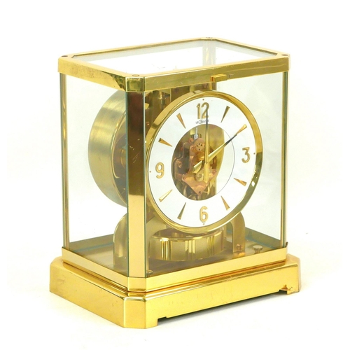 140 - A Jaeger LeCoultre Atmos clock, circa 1960s, with circular enamel Arabic dial, brass mounted glazed ... 