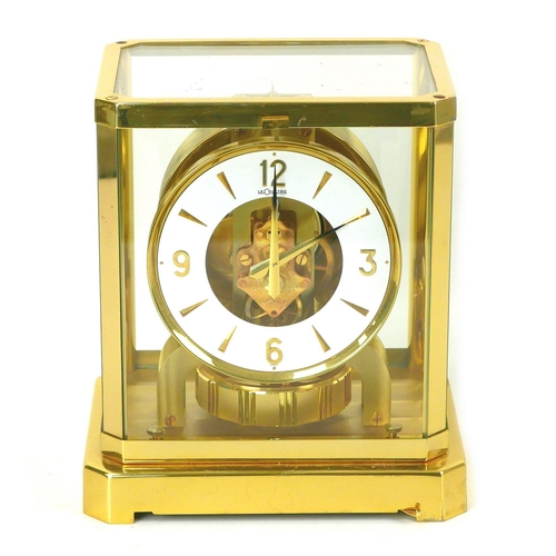 140 - A Jaeger LeCoultre Atmos clock, circa 1960s, with circular enamel Arabic dial, brass mounted glazed ... 