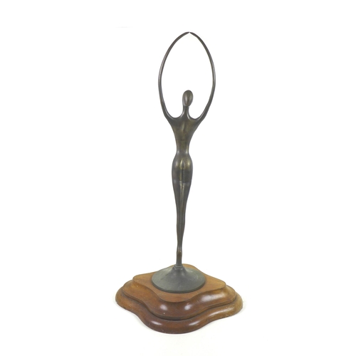 143 - An abstract bronzed female figurine of elongated form, raised upon a stepped mahogany base, unsigned... 