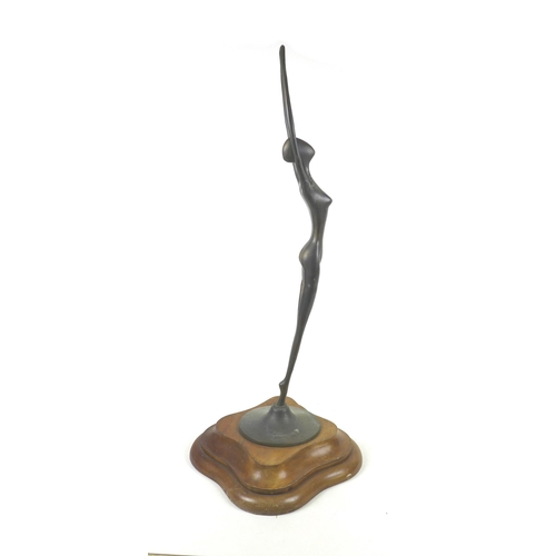 143 - An abstract bronzed female figurine of elongated form, raised upon a stepped mahogany base, unsigned... 