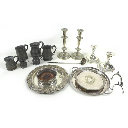 152 - A group of silver plated items, including two pairs of candlesticks, wine coasters, three trays, tod... 