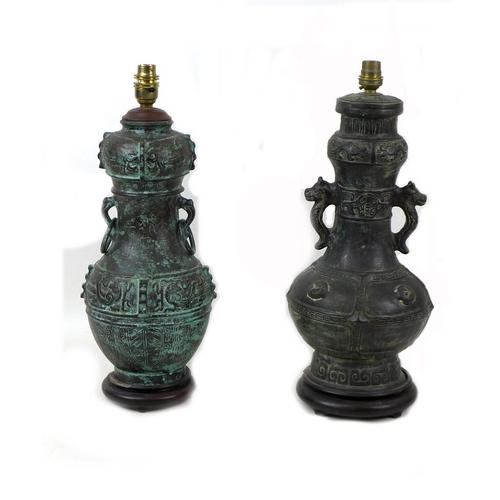 163 - Two 20th century Oriental style bronzed metal table lamps, both of baluster form raised upon wooden ... 