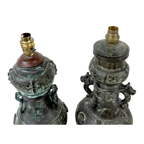 163 - Two 20th century Oriental style bronzed metal table lamps, both of baluster form raised upon wooden ... 