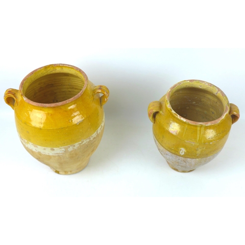 19 - Two late 19th/early 20th century French glazed stoneware confit pots, both with lug handles largest ... 