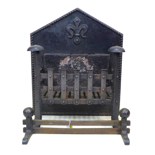 203 - A 17th century cast iron fire grate, the pointed arch back centred by a fleur-de-lys over an inset s... 