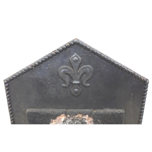 203 - A 17th century cast iron fire grate, the pointed arch back centred by a fleur-de-lys over an inset s... 