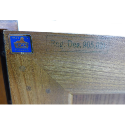 210 - An Ercol elm sideboard, with three central drawers flanked by two cupboards, all with recessed oval ... 