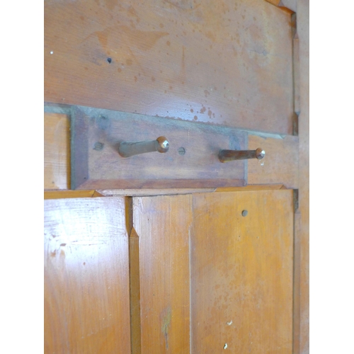 214 - A pair of five panelled stained pine doors with ceramic round handles and escutcheons, 91 by 4 by 21... 