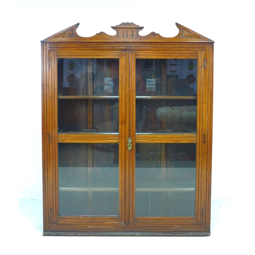 216 - A late Victorian mahogany display cabinet, with carved pediment, twin glazed doors, three adjustable... 