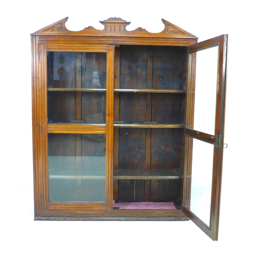 216 - A late Victorian mahogany display cabinet, with carved pediment, twin glazed doors, three adjustable... 