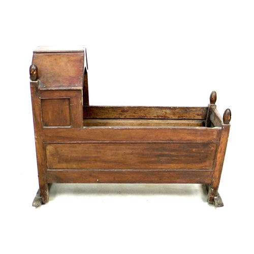 218 - A Victorian mahogany baby's crib, with finials to each corner, a shaped hood and raised on two rocke... 