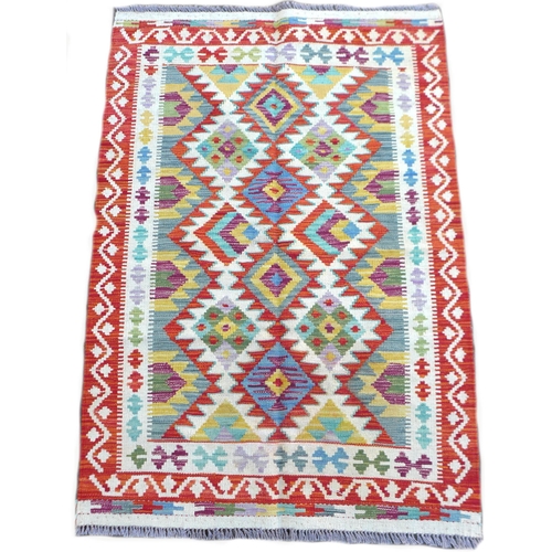 223 - A vegetable dye Chobi Kilim rug, featuring a colourful geometric design to its centre, with orange a... 