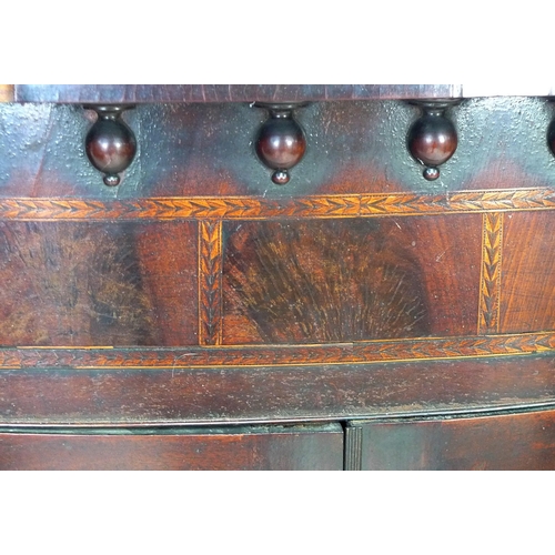 224 - An early Georgian mahogany bow fronted corner cupboard, unusual feather banding to the frize and fur... 