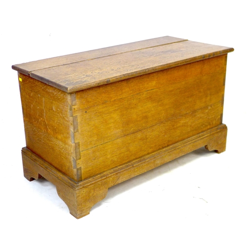 228 - A mid 20th century oak blanket chest, a/f top split, with lift lid, raised on bracket feet, 89 by 43... 