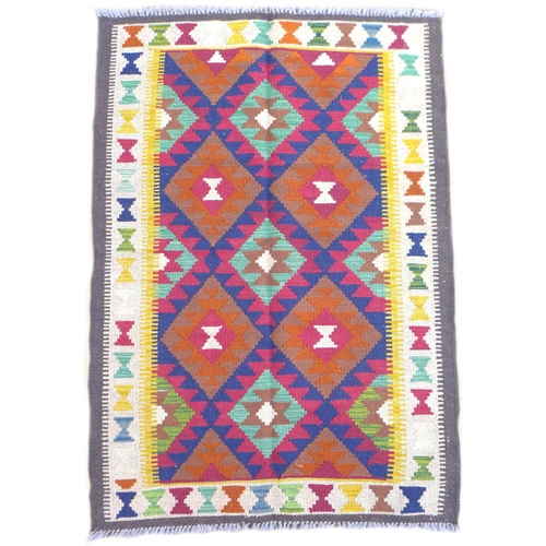 229 - A Maimana Kilim rug with dark blue ground, with multiple colourful lozenges, with a cream and brown ... 