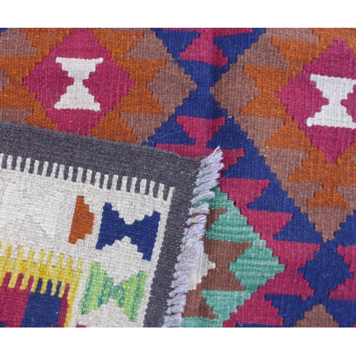 229 - A Maimana Kilim rug with dark blue ground, with multiple colourful lozenges, with a cream and brown ... 