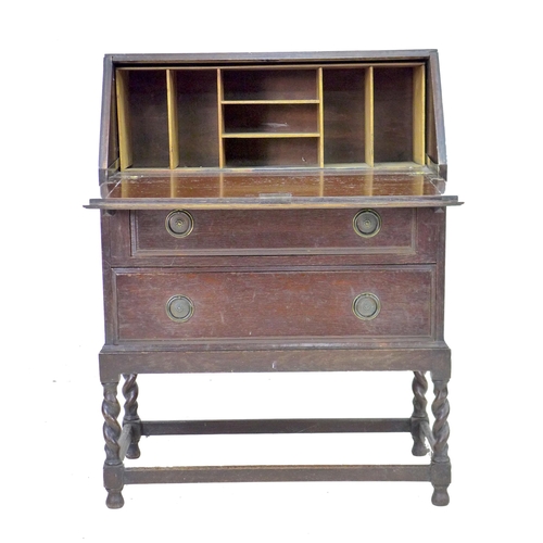 234 - A 1950s oak bureau bookcase, twin leaded glazed doors enclosing three shelves, fall front with fitte... 