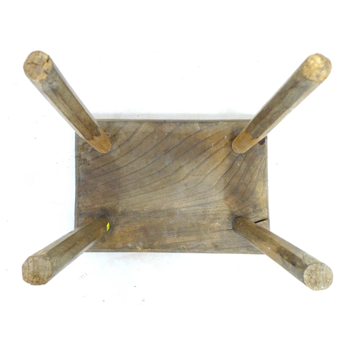 235 - An 18th century oak stool, the rectangular seat on outsplayed supports, the top 35.5 by 25cm, overal... 