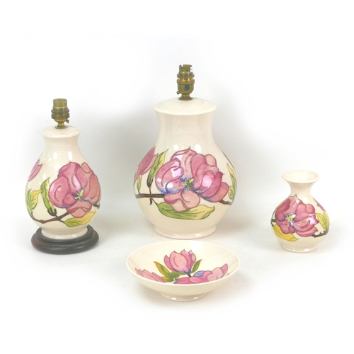 24 - Four pieces of Moorcroft Pottery Magnolia pattern wares, including two table lamps, largest, 18 by 3... 