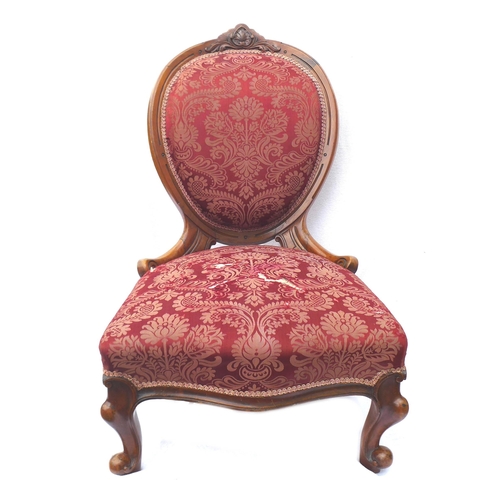 247 - A Victorian walnut framed nursing chair, with spoon shaped back, carved top rail, upholstered in a r... 