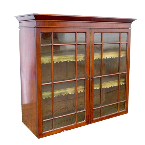 248 - An early Victorian mahogany bookcase, top section only, the twin doors with glazed panels, enclosing... 